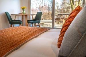 a bedroom with a bed with two chairs and a table at An Bothan in Isleornsay