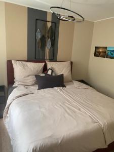 a bed with white sheets and pillows in a room at Gemütliche Wohnung in Ortsrandlage in Rüdesheim am Rhein