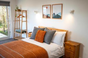 a bedroom with a bed with pillows and a ladder at An Bothan in Isleornsay +3 photos