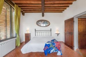 a bedroom with a bed and a large window at Universal Harmony - Usignolo in Dicomano