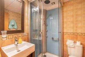a bathroom with a shower and a sink and a toilet at El Ático in Maluenda +14 photos