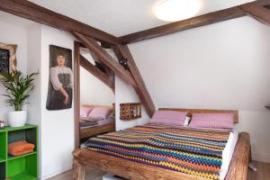 a bedroom with a wooden bed in a attic at Atelier-Loft im Hübschental in Gütenbach