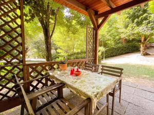 a table and two chairs on a porch with a table and chairs at Le sorgenti - Mobile Home 46 in Palazzuolo sul Senio