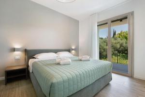 a bedroom with a bed and a large window at Residence Eleonora in Garda +41 photos