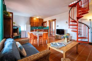a living room with a couch and a table at Pentavano White House in Isola Rossa