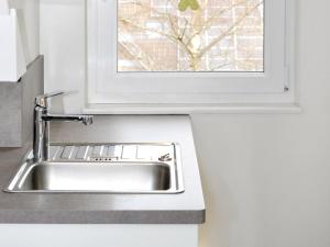 a kitchen sink with a window above it at Ferienwohnung Bock Feldmannshof in Drolshagen +17 photos