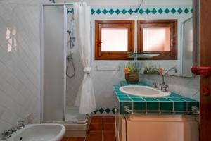 a bathroom with a sink and a shower at Pentavano White House in Isola Rossa +18 photos