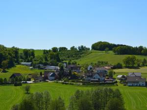 a small village on a hill with green grass at Ferienwohnung Bock Feldmannshof in Drolshagen