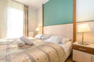 a bedroom with a large bed with white pillows at PrimeStayBudapest in Budapest
