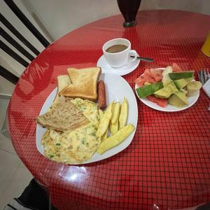 a table with two plates of food and a cup of coffee at Kilimanjaro Budget in Moshi