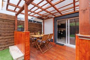 a patio with a table and chairs on a deck at Haus Zum Stumpfen Turm mit Sauna in Morbach +13 photos