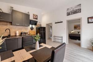 a kitchen and dining room with a table and a room with a bed at Haus Zum Stumpfen Turm mit Sauna in Morbach