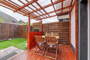 a patio with a table and chairs on a wooden deck at Haus Zum Stumpfen Turm mit Sauna in Morbach