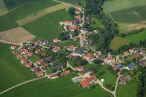 a large group of houses in a green field at Fewo Eitermoser Afrikanischer Traum in Pfaffing