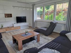a living room with a couch and a table at Ferienwohnung im Ries in Wallerstein