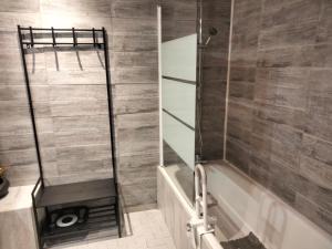 a shower with a glass door in a bathroom at Gîte du Bachat in Vorey +24 photos