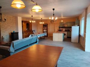 a living room with a blue couch and a table at Gîte du Bachat in Vorey