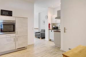 a kitchen and living room with a couch and a table at Jogis Ferienwohnungen in Freiburg im Breisgau