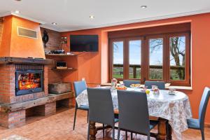 a dining room with a table and a fireplace at Casa Nueva in Salas