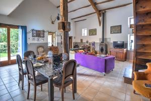 a dining room and living room with a table and chairs at Le Magicogite - Harry Potter in Larocal