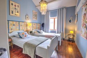 two beds in a bedroom with blue walls at Le Magicogite - Harry Potter in Larocal +34 photos