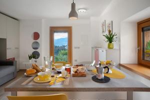 a kitchen with a table with food on it at Maso Plocech App Vacanze in Pergine Valsugana