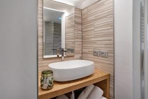 a bathroom with a white sink and a mirror at Maso Plocech App Vacanze in Pergine Valsugana