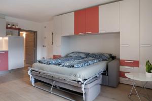 a bedroom with a bed in a room with cabinets at Maso Plocech App Vacanze in Pergine Valsugana