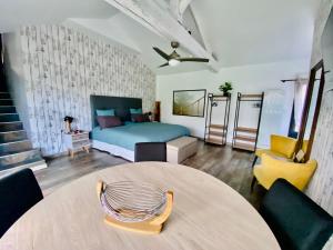 a bedroom with a bed and a table and chairs at La Cour de la Forêt in Saint-Mars-de-Coutais +35 photos