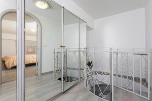 a staircase in a room with a mirror at Domus Elisae - Taormina in Taormina