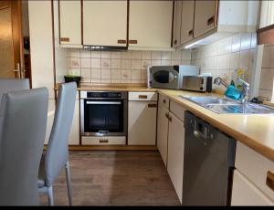 a kitchen with a sink and a stove top oven at Apartment Wohner in Petersaurach