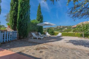 a patio with two chairs and an umbrella at Bel appartement à Saint-Maxime in Sainte-Maxime