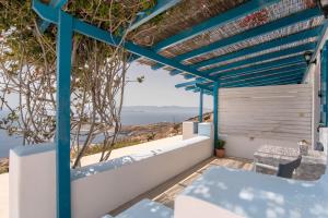 a blue pergola with a view of the ocean at Mesaria Home in Donoussa
