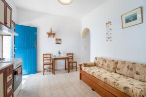 a living room with a couch and a table at Mesaria Home in Donoussa