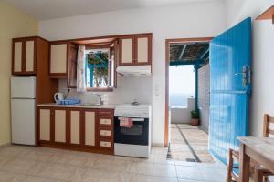 a kitchen with a sink and a stove at Mesaria Home in Donoussa