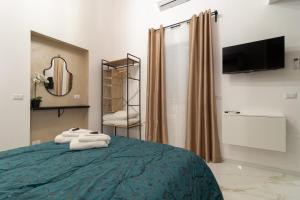 a bedroom with a bed with towels on it at Eralight21 Apartments in Bari