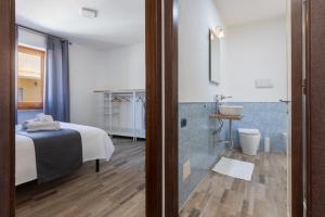 a hotel room with a bed and a bathroom at Max Apartment in Quartu SantʼElena +28 photos
