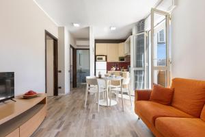 a living room with a couch and a table at Max Apartment in Quartu SantʼElena