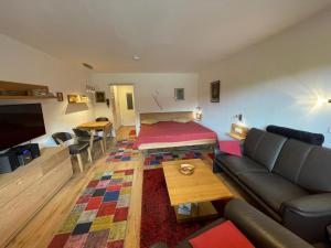 a living room with a couch and a bed at Ferienwohnung Inzell mit Bergblick in Inzell