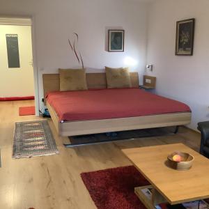a bedroom with a bed and a coffee table at Ferienwohnung Inzell mit Bergblick in Inzell