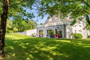a house with a green lawn in front of it at Kerwall - Maison d'hôtes in Malville