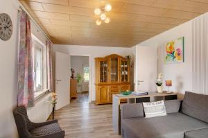 a living room with a couch and a table at Huus Karoline in Junkersrott