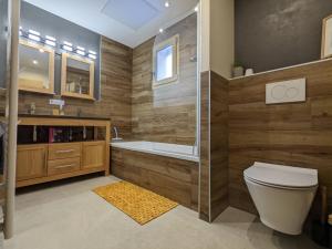 a bathroom with a tub and a toilet and a shower at Chalet Friwi in Saint-Jean-de-Sixt +34 photos