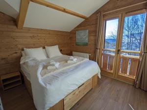 a bedroom with a bed with two stuffed animals on it at Chalet Friwi in Saint-Jean-de-Sixt