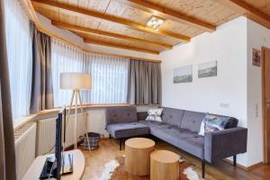 a living room with a couch and a tv at Auszeit in Donaueschingen