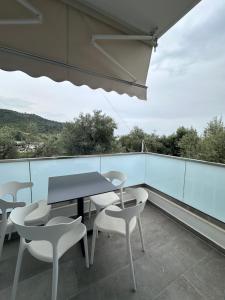 a table and chairs on a balcony with a view at Vila Melina in Himare