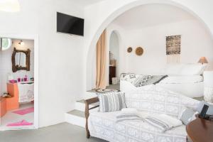 a white living room with a white couch at Antiparos - Sikinos Sunset in Sikinos