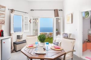 a kitchen and dining room with a table and chairs at Antiparos - Sikinos Sunset in Sikinos