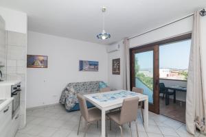 a kitchen and living room with a table and a couch at La Gioia in Palau