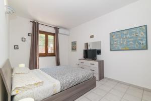 a bedroom with a bed and a television in it at La Gioia in Palau